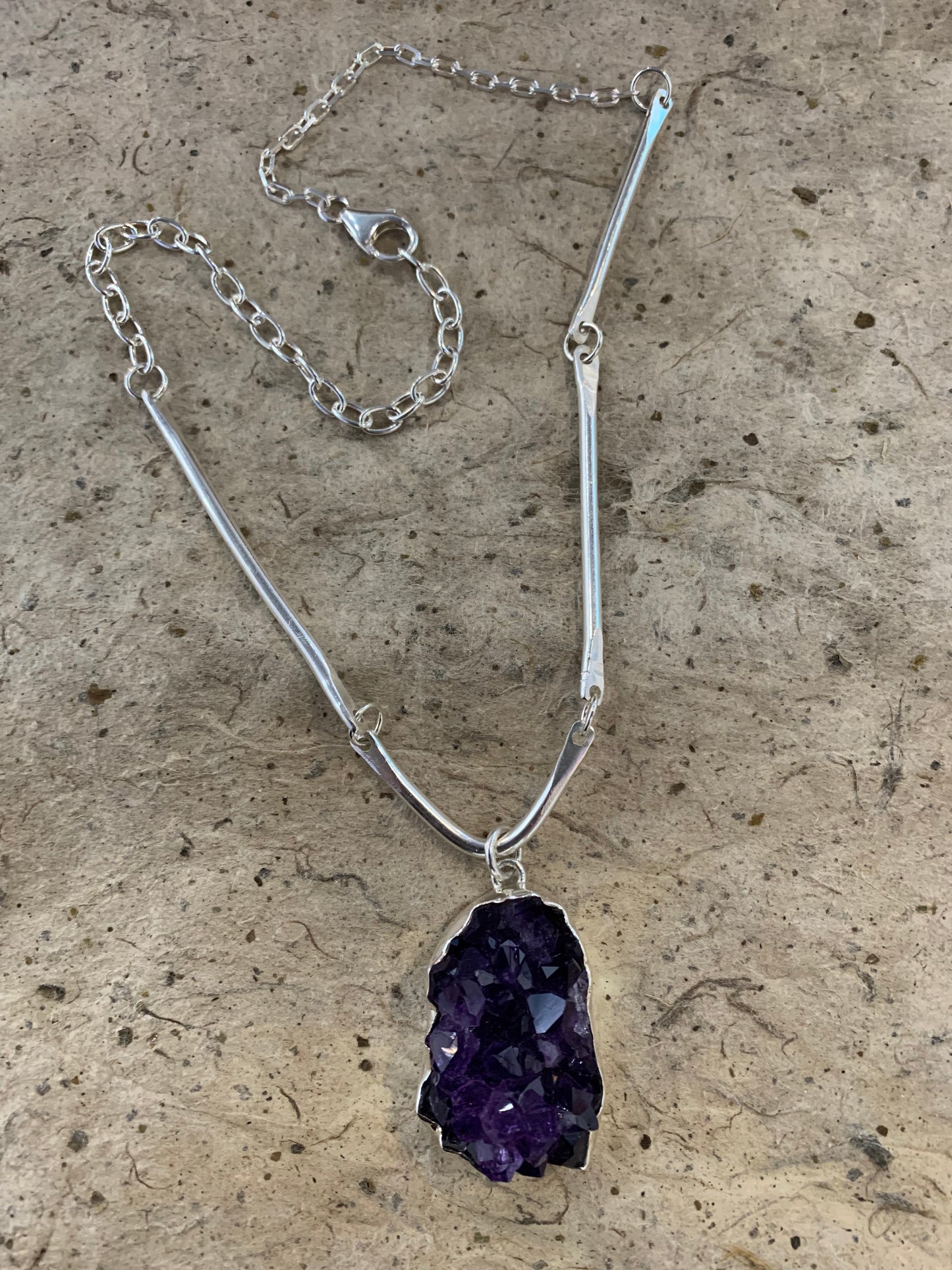 Hand forged sterling silver chain in a unique design set with a raw piece of African Amethyst