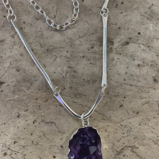 A video of a beautiful deep purple African amethyst cluster and sterling silver statement necklace that shows the individual crystal facets and points 