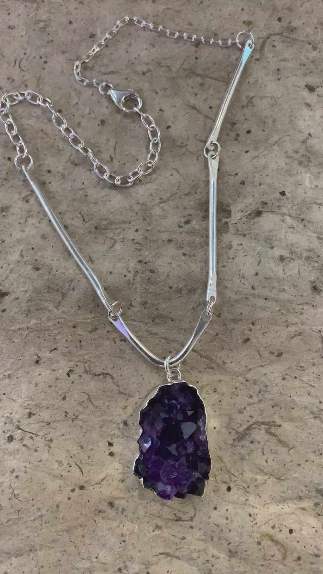 A video of a beautiful deep purple African amethyst cluster and sterling silver statement necklace that shows the individual crystal facets and points 